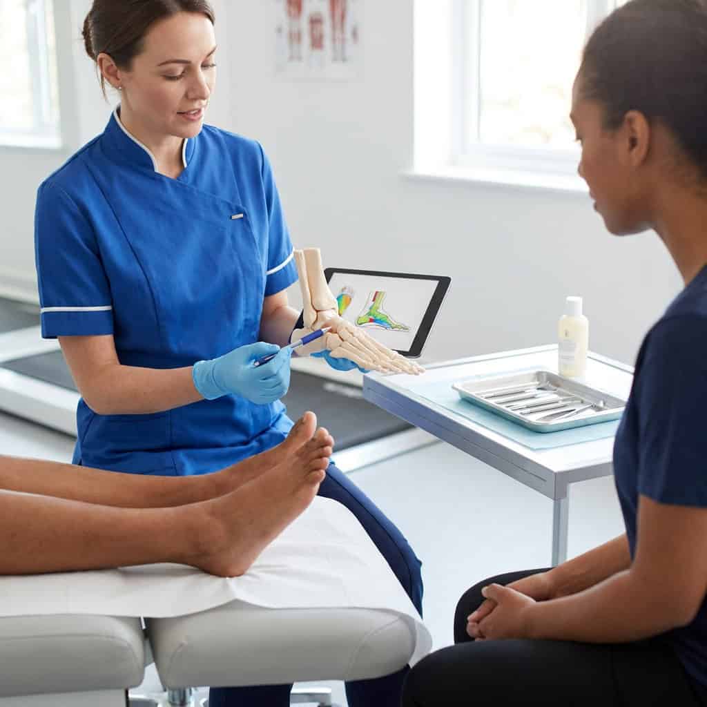 Podiatrist explaining foot health assessment to patient during screening in Ballymena.